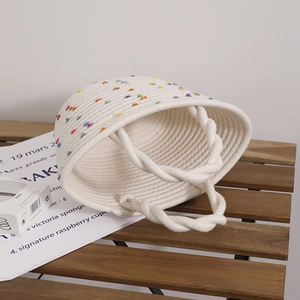 Handwoven white cotton rope bag with colorful pompoms for beach holidays and casual style