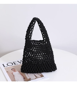 Macro shot of minimalist black woven mesh bag texture and integrated handle design