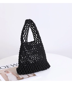 Detail view of the black hand-woven cotton net bag with intricate knot patterns