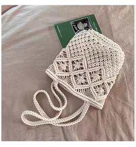 Detail of macrame shoulder bag showing intricate diamond hollow pattern and woven texture