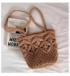 Detailed macro view of handcrafted hollow woven cotton shoulder bag with intricate patterns