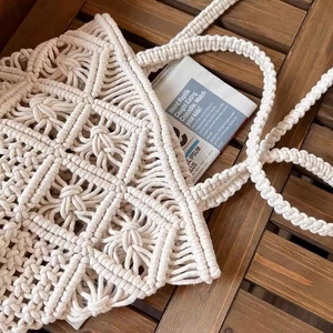 Detailed close-up of handmade cream cotton cord macrame weave on a bohemian tote bag