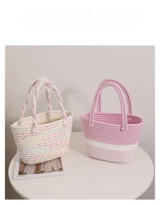 Detail of woven cotton stripe tote bags and polka dot straw baskets for beach holiday