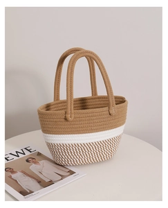 Detail of hand-woven cotton rope tote bag showing its natural texture and neutral color tones