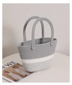 Close-up of pink twisted cotton rope woven handbag with grey white checkered patterns
