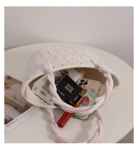 Top view of pink braided cotton tote bag showing interior capacity with personal items