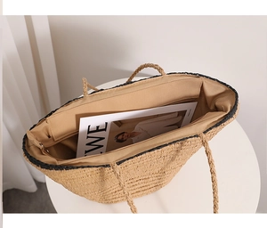 Detail of handwoven straw tote featuring large capacity with fabric lining and zip pocket