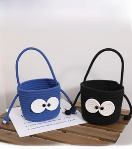 Close-up of woven bucket bags with cute big eyes design in navy blue and black
