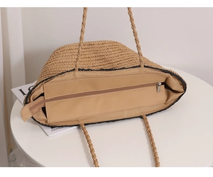 Detail view of the woven tote bag interior with beige fabric lining and secure zipper closure