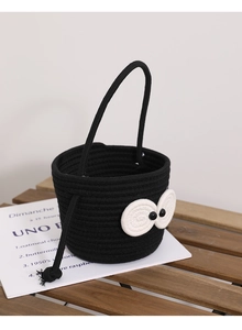 Macro shot of black cotton rope bucket bag featuring unique big eye crochet detailing