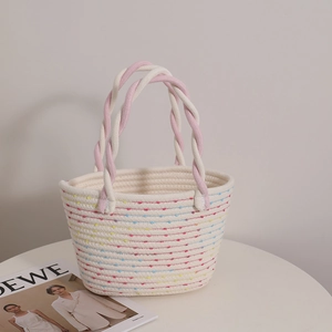Retro woven cotton tote with colorful stripes and pink twisted handles for beach holiday