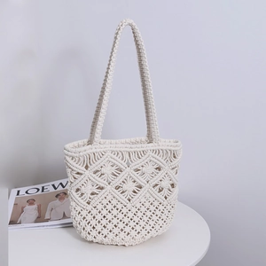 Minimalist white macrame woven tote bag with geometric openwork design for beach vacation