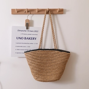 French retro straw tote bag with black trim and long handles for beach vacations
