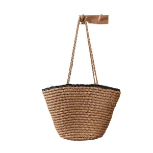 French vintage straw tote bag with black trim and long shoulder straps for beach vacation