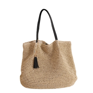 Large French vintage woven straw tote bag with black leather straps and tassel detail