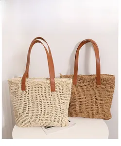 Detail of checkered woven tote bags with leather handles and hollow knit design