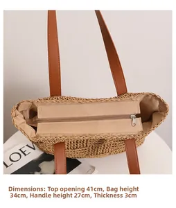 Detail shot of woven straw tote bag featuring zipper closure and internal measurements