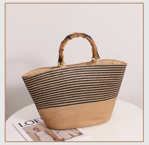Detail of bamboo handles and striped woven texture on a vintage French straw tote bag