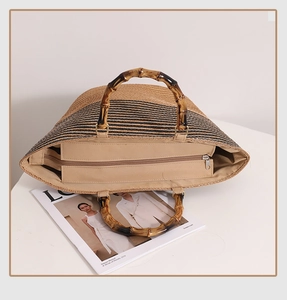 Detail of the spacious interior with zipper closure and bamboo handles on a striped tote