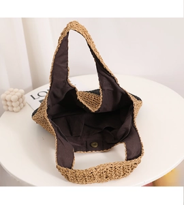 Detailed view of handmade woven straw bag interior with lining and magnetic clasp