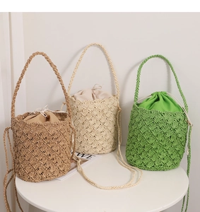 Three hand-woven straw bucket bags with hollow diamond patterns and drawstring linings
