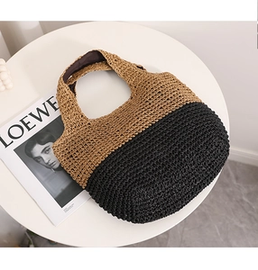 Detail showing the two-tone straw weaving pattern in natural beige and black on the tote