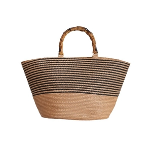 French vintage straw tote bag with black stripes and bamboo handles for beach vacations