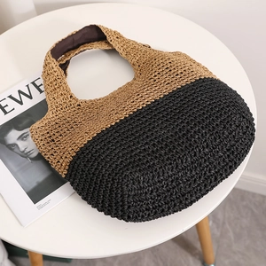 Contrast woven straw handbag with a natural and black color-block design for beach vacations