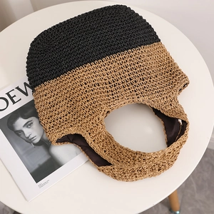 Minimalist straw tote bag with black and beige contrast weave for beach vacations