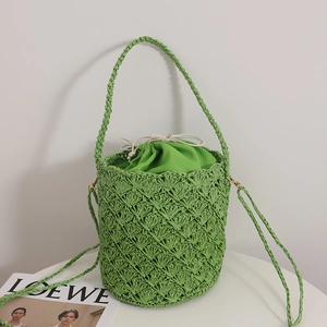 French retro straw bucket bag in green with hollow weave and drawstring liner