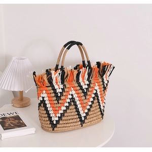French vintage straw tote bag with colorful fringe edges and striped pattern for beach