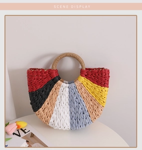 Detail shot of multi-color woven straw handbag with semicircular design and round handle