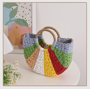 Detail of colorful rainbow woven straw tote bag with round handles for beach vacations