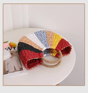 Detail of multi-color rainbow straw handbag with hand-woven colorful striped textures
