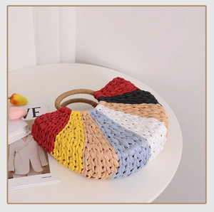 Detail of colorful woven straw tote with round handles for beach vacation style