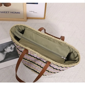 Detail of bohemian woven tote bag showing striped texture and green lining with zipper