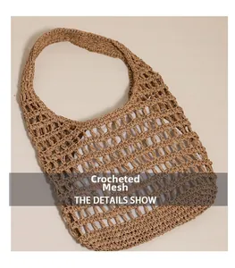 Detail of hollow crochet texture on khaki straw tote bag for beach vacation style
