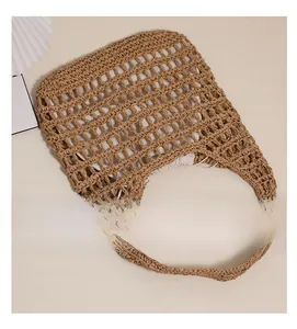 Detail of hand-woven straw tote with cotton drawstring liner for travel and beach use