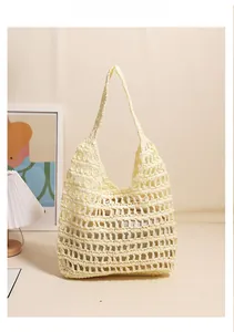 Detail of hand-woven straw tote bag with mesh hollow pattern and inner fabric lining