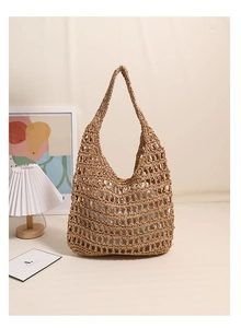Detail of hand-woven straw tote bag with hollow mesh design and soft natural texture