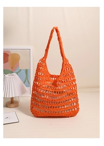 Detail of orange hollow crochet tote bag with a removable white drawstring inner pouch