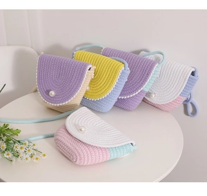 Detailed shot of colorful knitted crossbody bags with pearl closure and braided straps