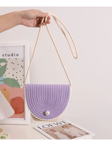 Detail of lilac and beige woven crossbody bag featuring a large pearl button closure