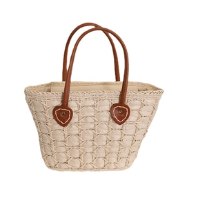 Minimalist straw tote bag with heart grid pattern and brown faux leather handles