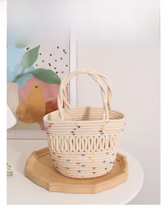 Close-up of a cream woven basket bag with colorful bean accents and spiral handles