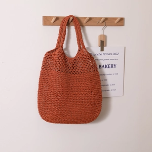 Retro handmade hollow straw tote bag in terracotta red, ideal for beach holidays and travel