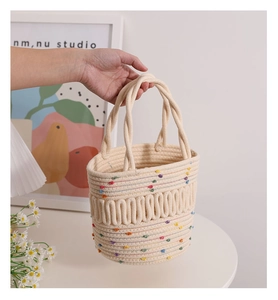 Detail of colorful polka dot woven bucket bag with unique 3D wave textured pattern finish