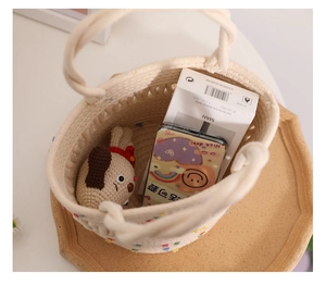 Close-up of white woven cotton bucket bag with colorful dots and a cute plush toy inside