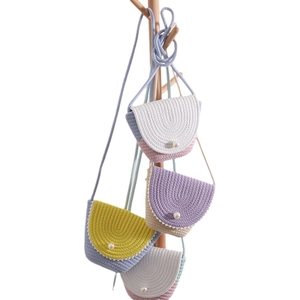 Handmade straw crossbody bags with pearl buttons for kids, set of four colorful designs