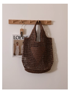 Detailed macro view of dark brown crochet mesh tote bag featuring woven heart pattern